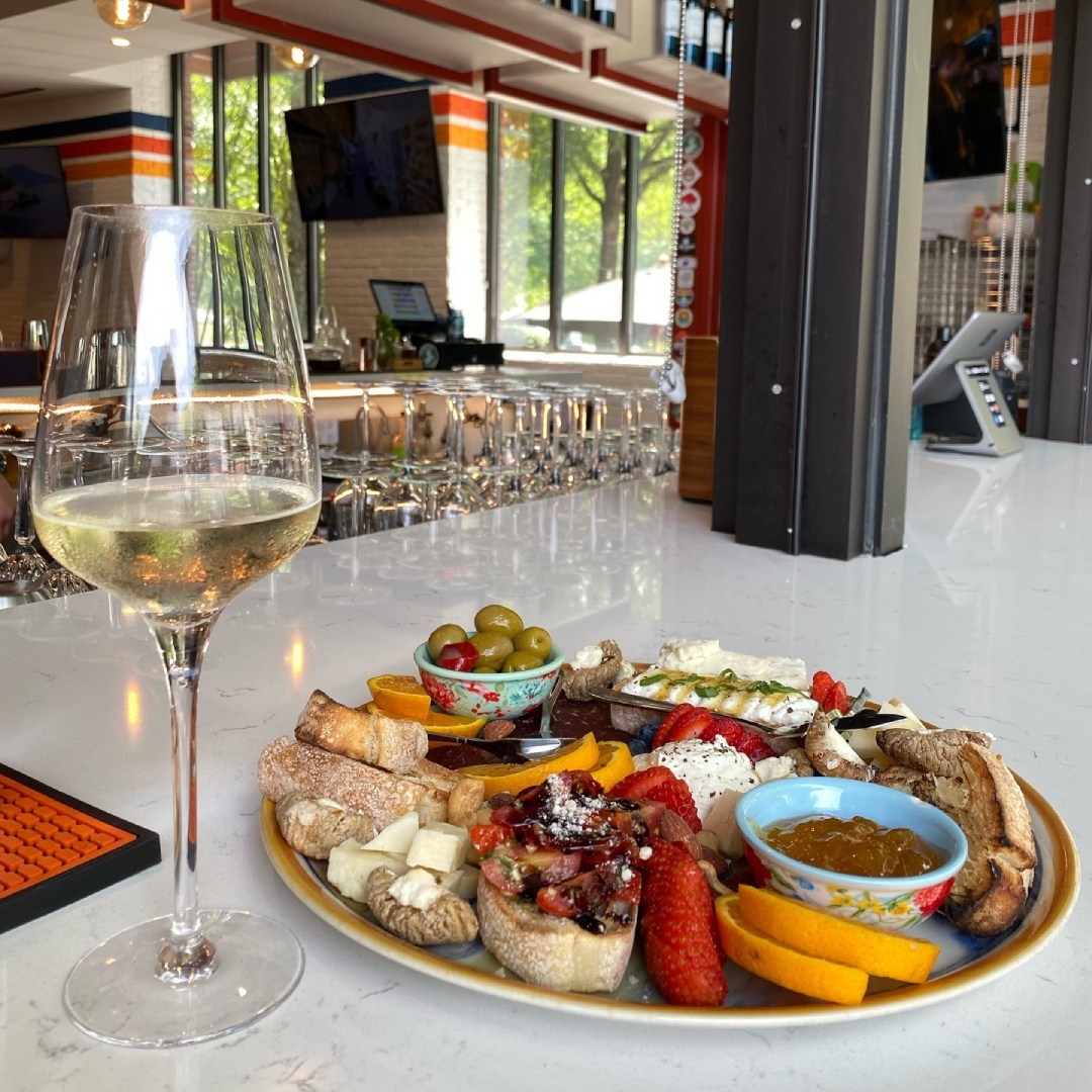Charcuterie platter with glass of white wine from Positano Pizza